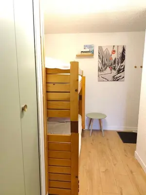 a small room with a bunk bed and a table at Le Nid d'Amélie Studio 4 people mountain view in Combloux