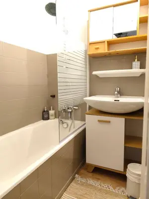 a bathroom with a white tub and a sink at Le Nid d'Amélie Studio 4 people mountain view in Combloux