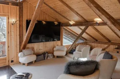 a living room with chairs and a large window at Chalet Paris Mont-Blanc Luxe et authenticite in Saint-Gervais-les-Bains