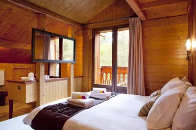 a bedroom with a large bed in a wooden cabin at Marmotte Mountain Retreat in Chamonix-Mont-Blanc