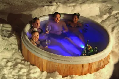 a group of people sitting in a hot tub at Marmotte Mountain Retreat in Chamonix-Mont-Blanc