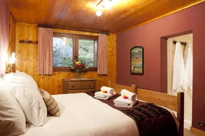 a bedroom with a bed with towels on it at Marmotte Mountain Retreat in Chamonix-Mont-Blanc