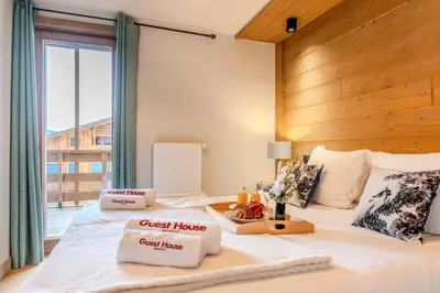 a tray with a plate of food on a bed at Discreet Alpine Luxury Suite Art of Living in Megève in Megève