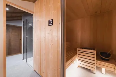 a dining room with a table and a chair at Discreet Alpine Luxury Suite Art of Living in Megève in Megève