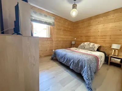 a bedroom with wooden walls and a bed in it at Appartement lumineux 3 pièces proche des pistes avec WiFi et parking - FR-1-572-343 in Arâches-la-Frasse