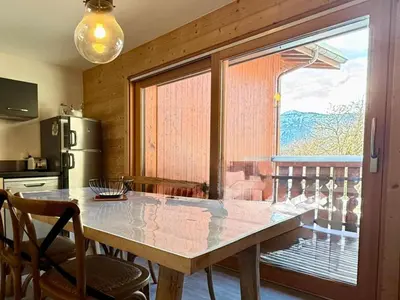 a kitchen with a table and a large window at Appartement lumineux 3 pièces proche des pistes avec WiFi et parking - FR-1-572-343 in Arâches-la-Frasse
