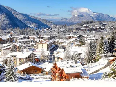 a town covered in snow with a mountain in the background at Appartement lumineux 3 pièces proche des pistes avec WiFi et parking - FR-1-572-343 in Arâches-la-Frasse