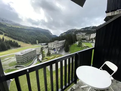 a table and a chair on a balcony with a view at Résidence Aldébaran - maeva Home - Appartement au pied des pistes 2 pièces 6 personnes - Budget MAE-9763 in Flaine