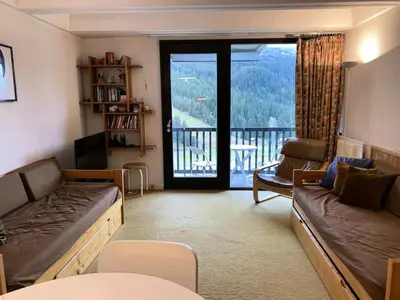 a living room with a couch and a balcony at Résidence Aldébaran - maeva Home - Appartement au pied des pistes 2 pièces 6 personnes - Budget MAE-9763 in Flaine