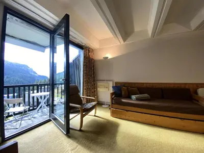 a bedroom with a bed and a balcony at Résidence Aldébaran - maeva Home - Appartement au pied des pistes 2 pièces 6 personnes - Budget MAE-9763 in Flaine