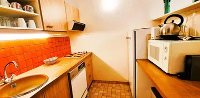 a small kitchen with a sink and a refrigerator at Résidence Aldébaran - maeva Home - Appartement au pied des pistes 2 pièces 6 personnes - Budget MAE-9763 in Flaine