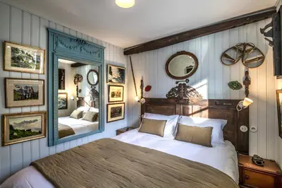 a bedroom with a large bed and a mirror at Chalet La Renarde in Chamonix-Mont-Blanc