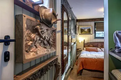 a room with a bedroom with a bed and a mirror at Chalet La Renarde in Chamonix-Mont-Blanc