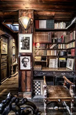 a room with a library with a desk and books at Chalet La Renarde in Chamonix-Mont-Blanc