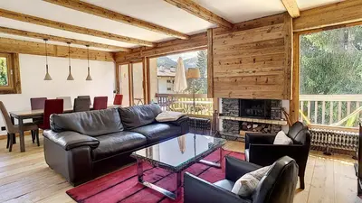 a living room with leather furniture and a fireplace at Riante Colline Edelweiss - PROCHE CENTRE 3 chambres- balcon in Megève