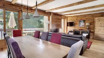 a dining room with a large wooden table and chairs at Riante Colline Edelweiss - PROCHE CENTRE 3 chambres- balcon in Megève