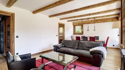 a living room with a leather couch and a table at Riante Colline Edelweiss - PROCHE CENTRE 3 chambres- balcon in Megève