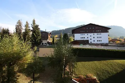 a group of buildings and trees in a city at Rochebrune, proche piste rr6171 in Megève