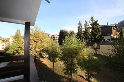 a view of a yard with trees and buildings at Rochebrune, proche piste rr6171 in Megève
