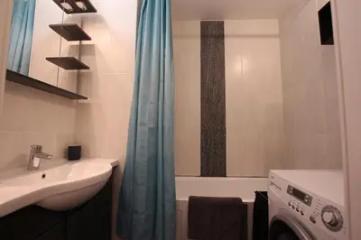 a bathroom with a sink and a washing machine at Rochebrune, proche piste rr6171 in Megève