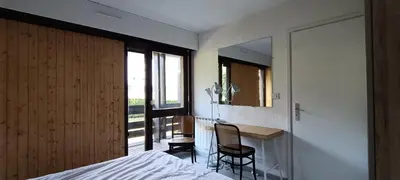 a bedroom with a bed and a desk and a mirror at Rochebrune, proche piste rr6171 in Megève