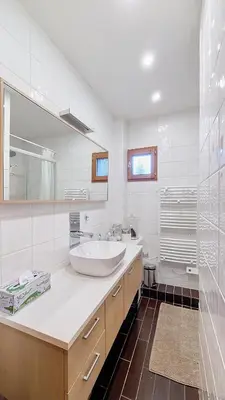 a white bathroom with a sink and a shower at Les Perchets - PROCHE CENTRE - 2 chambres in Megève