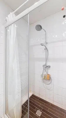 a shower with a glass door in a bathroom at Les Perchets - PROCHE CENTRE - 2 chambres in Megève