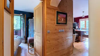 a room with a wooden wall in a house at Les Perchets - PROCHE CENTRE - 2 chambres in Megève