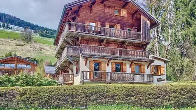 a large wooden house with decks on a hill at Primeveres 1 - JAILLET - PROCHE CENTRE - in Megève