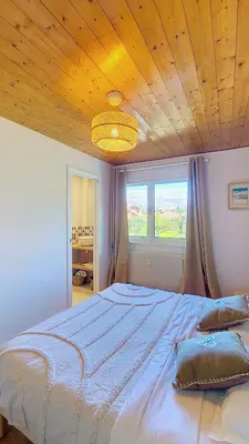 a white bedroom with a bed and a window at Saint Michel - JAILLET - grand 3 chambres in Megève