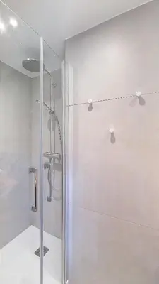 a shower with a glass door in a bathroom at Saint Michel - JAILLET - grand 3 chambres in Megève