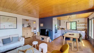 a living room with a couch and a table at Saint Michel - JAILLET - grand 3 chambres in Megève