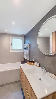 a bathroom with a sink and a tub and a mirror at Saint Michel - JAILLET - grand 3 chambres in Megève