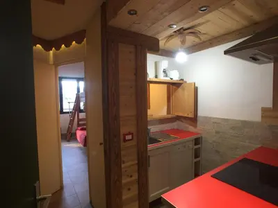 a kitchen with a door leading into a room at Chamonix Holiday Cromotherapy Apartment 1 in Chamonix-Mont-Blanc