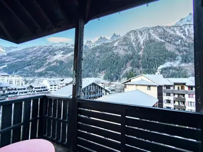 a balcony with a view of a city and mountains at Studio exceptionnel, tout équipé face à l'aiguille du midi in Chamonix-Mont-Blanc