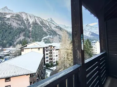 a view from the balcony of a building with snow covered mountains at Studio exceptionnel, tout équipé face à l'aiguille du midi in Chamonix-Mont-Blanc