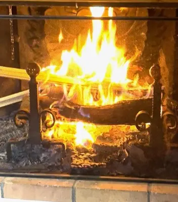 a fire in an oven with flames in it at Red Fir Chalet in Megève
