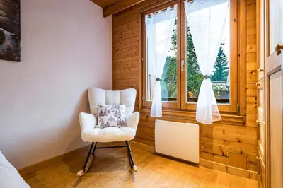 a white chair in a room with a window at Renovated Apartment 7p Argentière - Close to Slopes! in Chamonix-Mont-Blanc