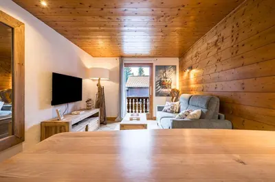 a living room with a couch and a television at Renovated Apartment 7p Argentière - Close to Slopes! in Chamonix-Mont-Blanc