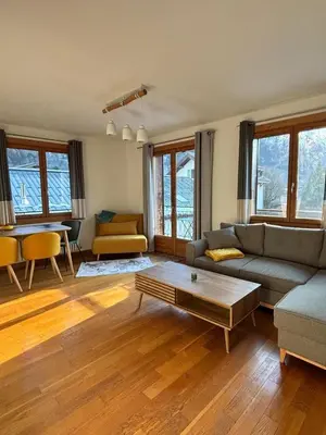a living room with a couch and a table at Home in Chamonix Bossons in Chamonix-Mont-Blanc