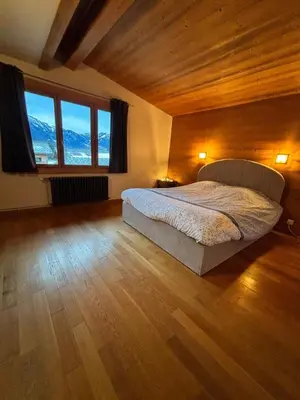 a bedroom with a bed and a large window at Home in Chamonix Bossons in Chamonix-Mont-Blanc