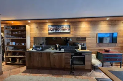 a large kitchen with a sink and a stove at Le Menhir Chalets de Lady in Megève