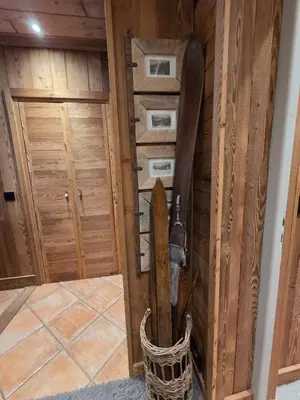 a room with a wooden wall with skis in it at Le Menhir Chalets de Lady in Megève
