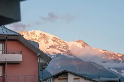 a mountain in the distance with a building in front at Grand Panorama-au pied du télécabine le Valléen-4pers in Saint-Gervais-les-Bains