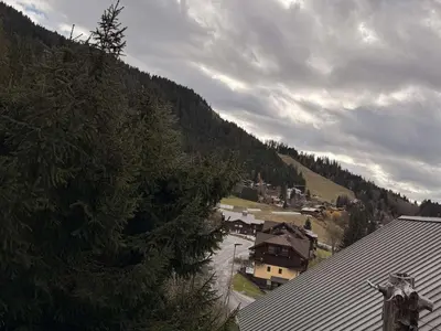 a view of a village with a house and a mountain at Studio mezzanine ensoleillé, proche pistes, Les Carroz d'Arâches - FR-1-572-346 in Arâches-la-Frasse