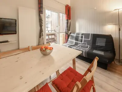 a living room with a wooden table and a couch at P Les Esserts N57 2P4 in Morillon
