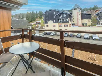 a balcony with a table and a view of a parking lot at P Les Esserts N57 2P4 in Morillon