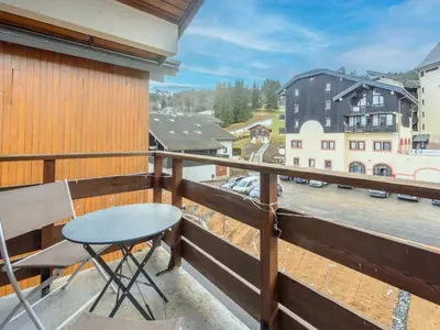 a balcony with a table and a view of a city at P Les Esserts N57 2P4 in Morillon
