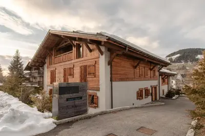 a log cabin with a stove in front of it at Kara Gypaete - Charme - Proche village in Megève