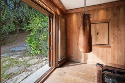 a porch with a large window and a copper jug at Luxury Chalet Sauna Cinema Mont Blanc Views in Megeve in Megève